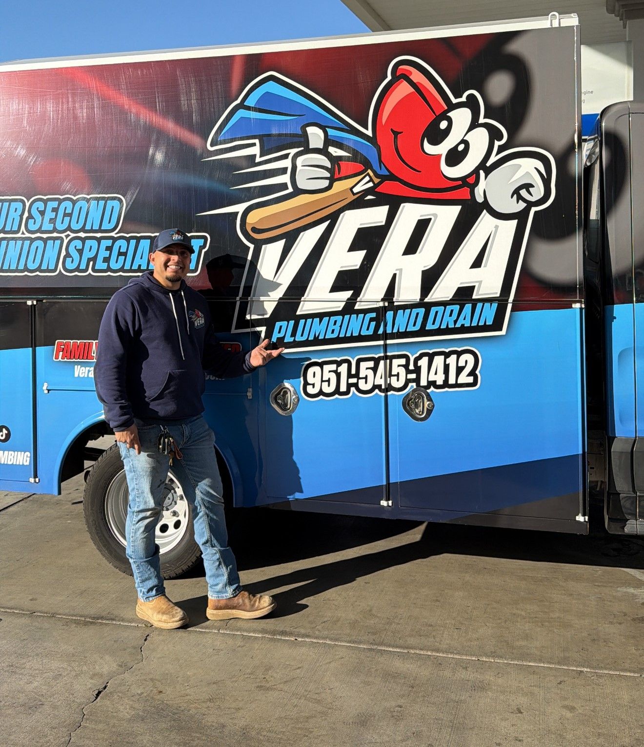 Vera Plumbing and Drain technician standing by branded service van in Jurupa Valley, CA