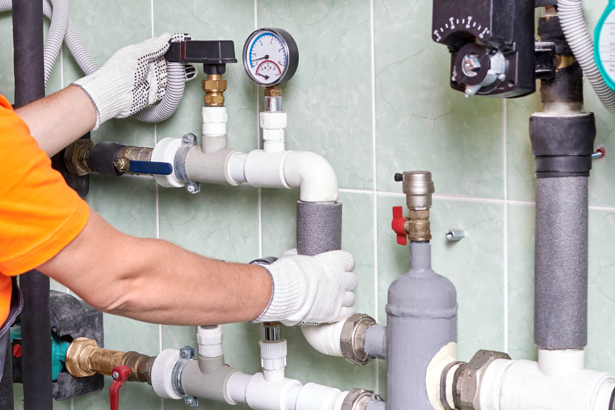 Commercial plumber working on pipes at a job site for Vera Plumbing & Drain in Jurupa Valley, CA