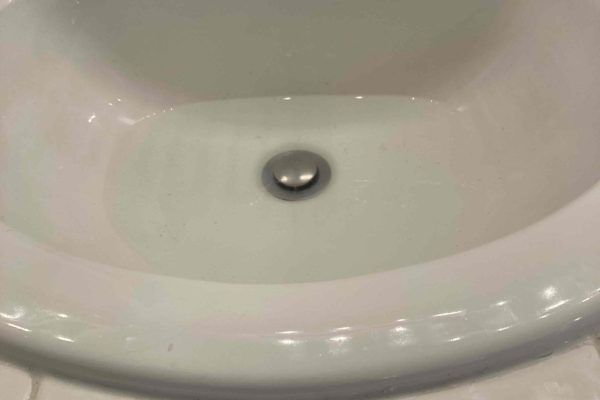 Kitchen sink drain close-up for garbage disposal installation service in Jurupa Valley, CA