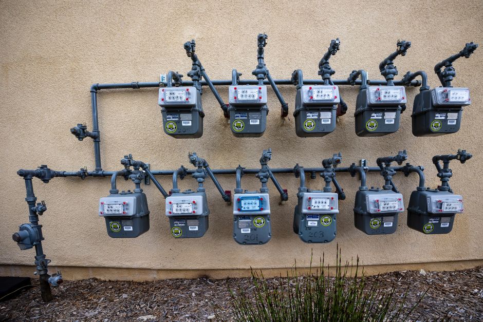Exterior wall-mounted gas meters and piping on a residential building in Jurupa Valley, CA