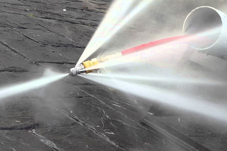 Hydro jetting nozzle blasting high-pressure water inside a drain pipe for drain cleaning service in Jurupa Valley, CA
