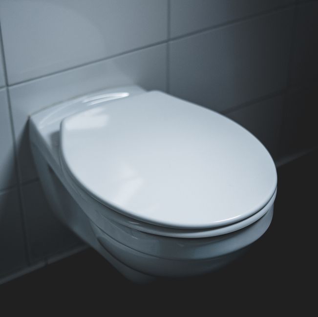 Sleek white toilet in a clean bathroom — toilet repair and installation services in Jurupa Valley, CA